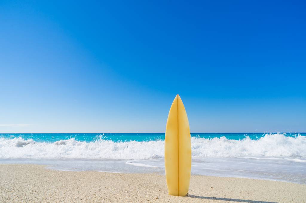 waves on the beach with a surfboard - hawaii in summertime