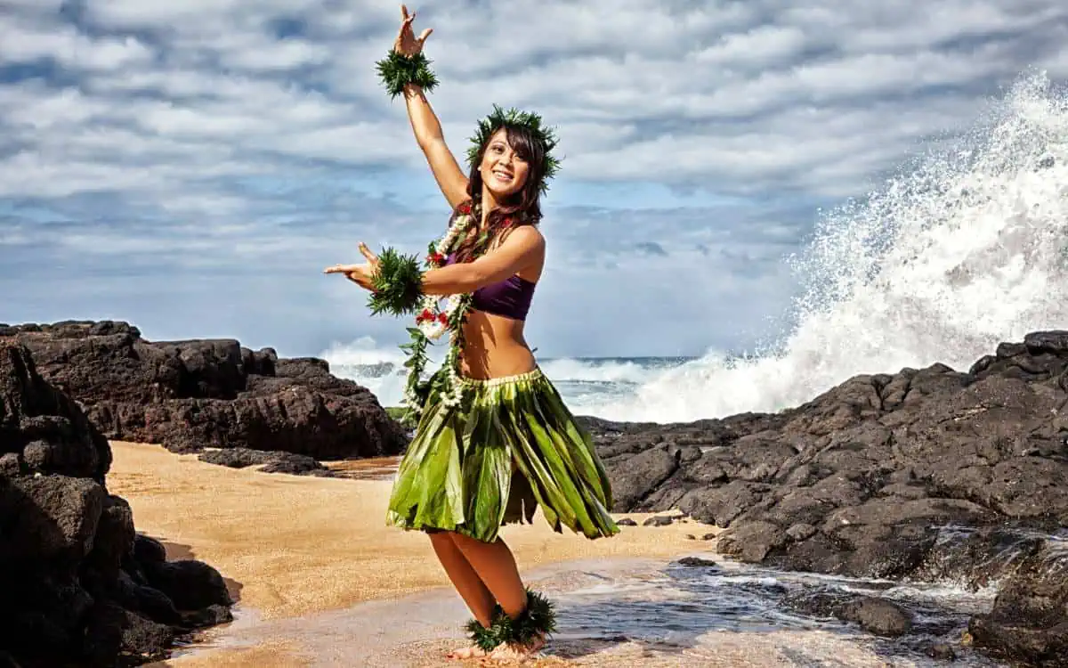 hula dancer in the waves on a beach - kauai cultural activities_1