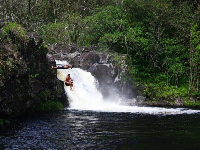 umauma-fall-and-zipline-experience-big-island-two-man-jump-in-the-water