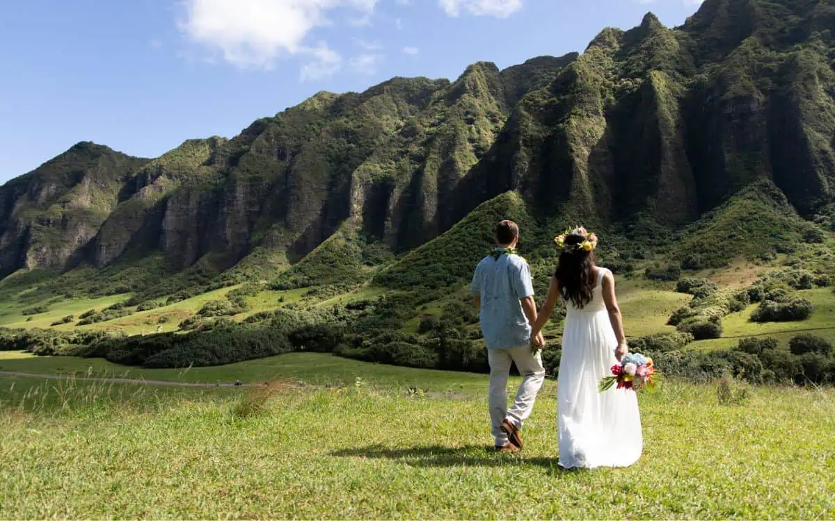 planning a hawaii wedding bride and groom walk with views of koolau mountains